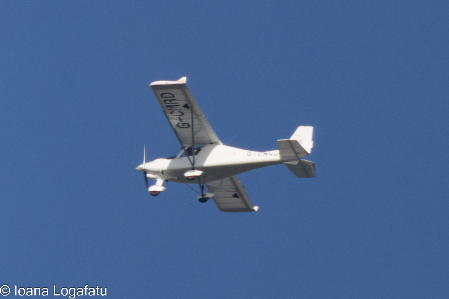 Flying high above a clear blue sky on a sunny day